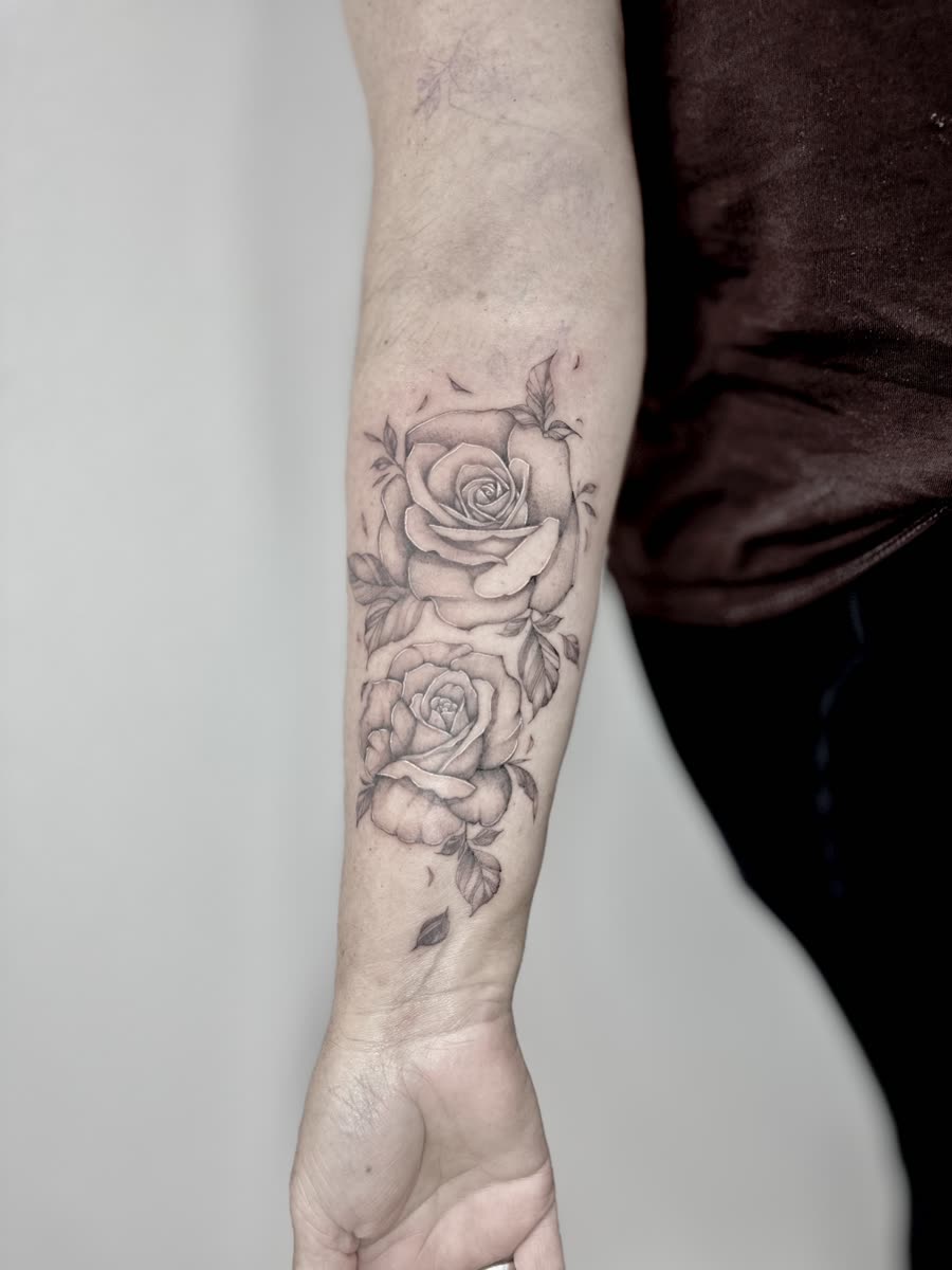 Double rose fineline tattoo on a forearm