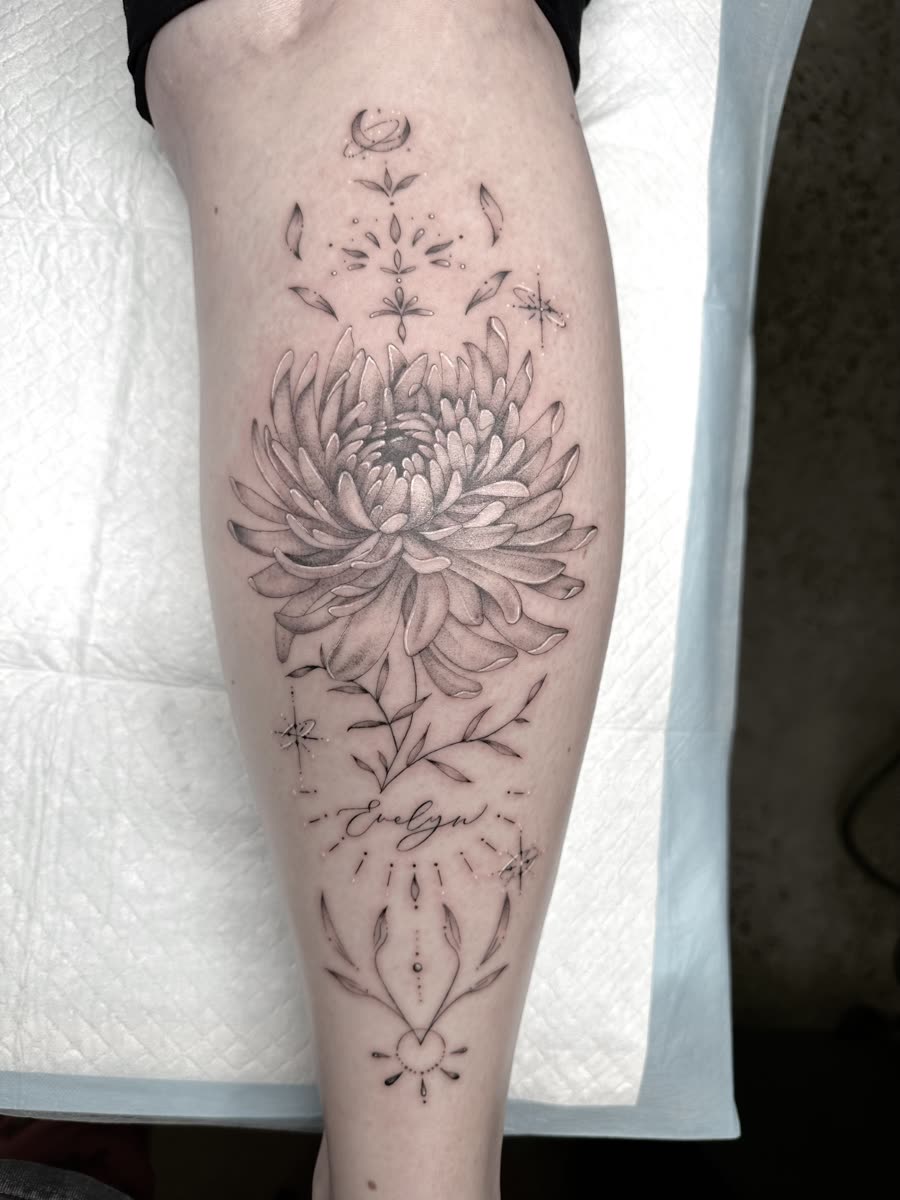 Ornamental chrysanthemum tattoo on a calf